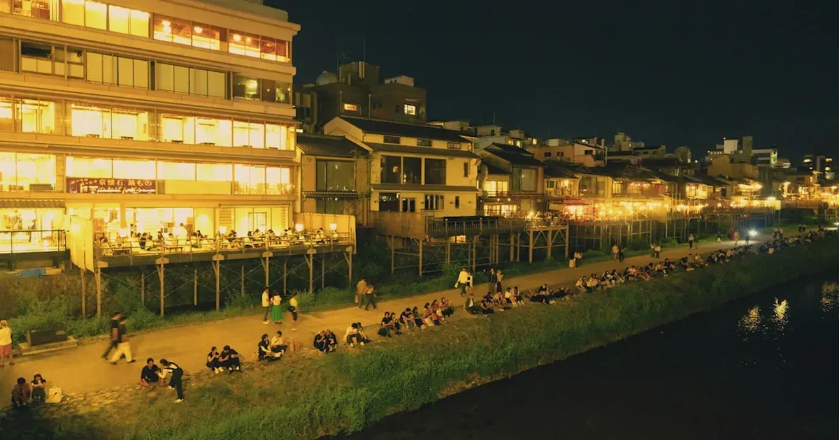 Fukuoka yatai open-air food stalls lit up at night along the Naka River