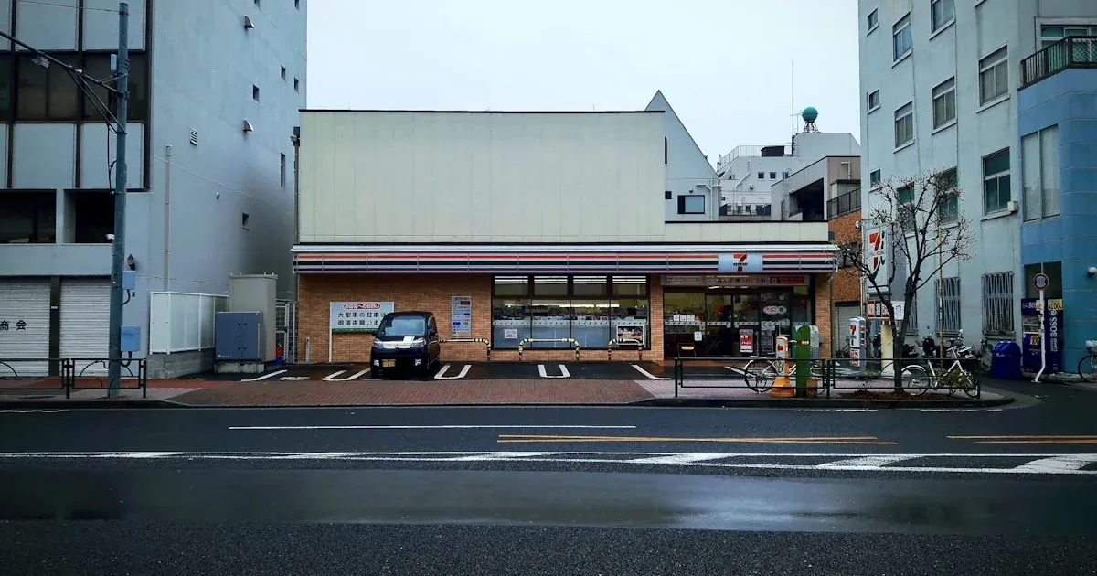 Inside a Japanese 7-Eleven with rows of onigiri and bento boxes