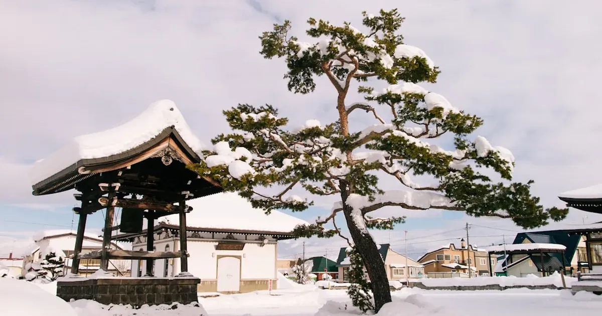 Quiet snow-covered Japanese temple in winter — Japan's cheapest season