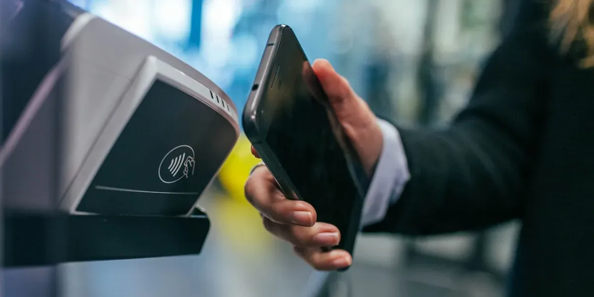 Contactless credit card being tapped on a payment reader at a Japanese store