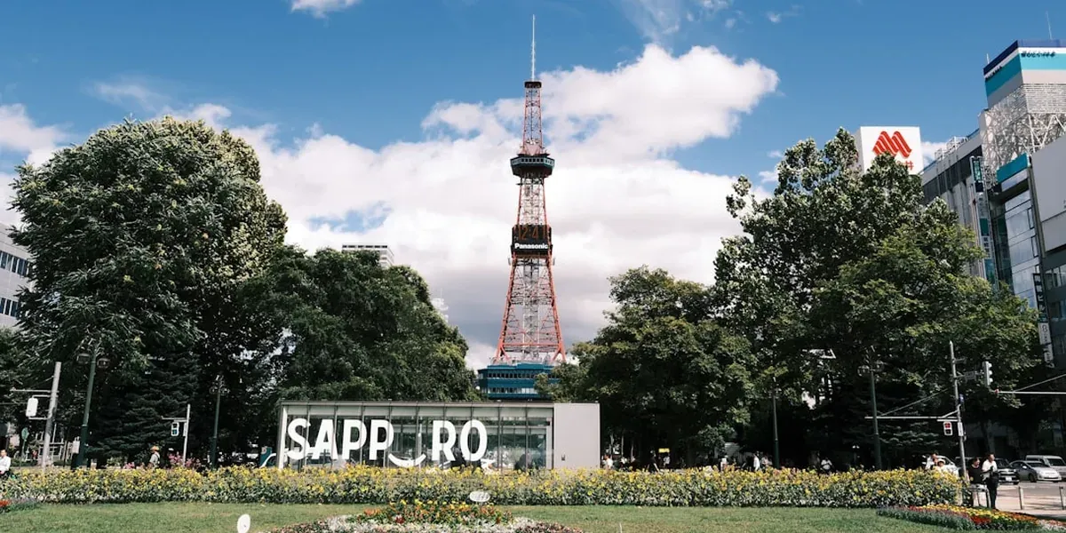 Odori Park in central Sapporo in summer with flowers, lawns, and the TV tower in the background