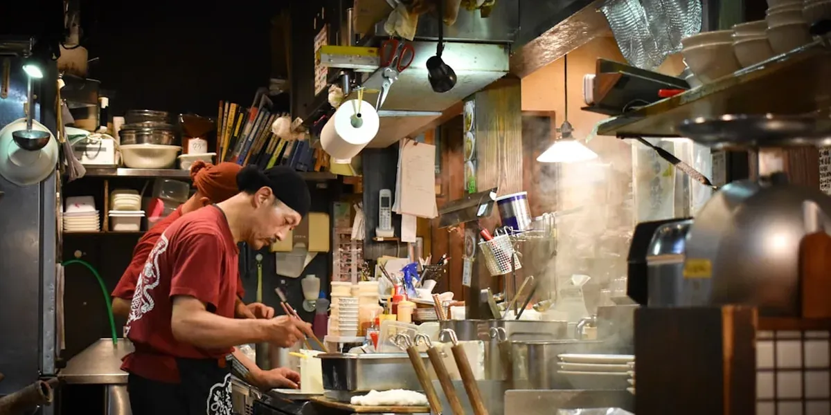 A Japanese ramen shop counter with single diner seat, illustrating solo-friendly eating