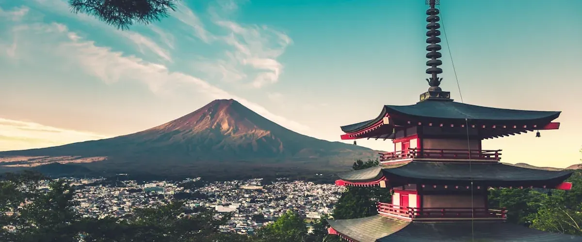 Chureito Pagoda with Mount Fuji and cherry blossoms in the background on a clear spring day