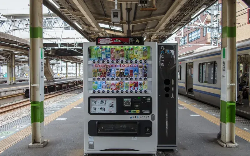 Japan train station ticket vending machine showing route options and fares