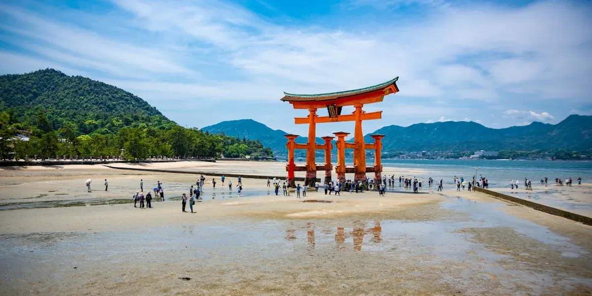 Itsukushima Shrine floating torii gate standing in the sea at high tide on Miyajima Island