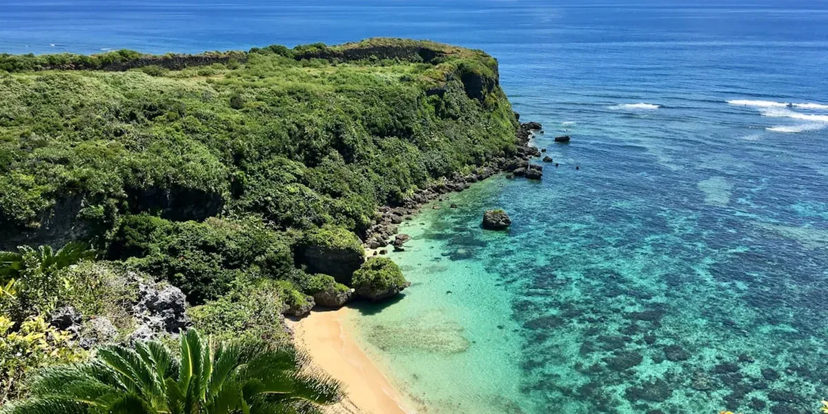 Crystal-clear turquoise tropical water with white sand in Okinawa with fish visible through the surface