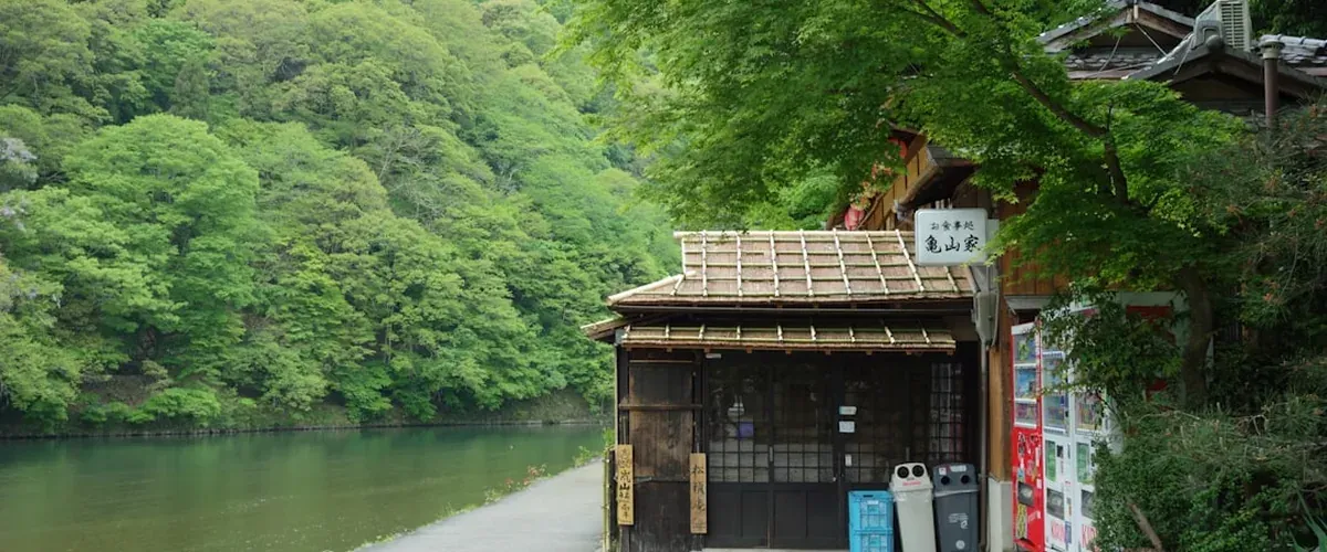 Onsen washing station with small stool, bucket, and handheld shower at a Japanese hot spring