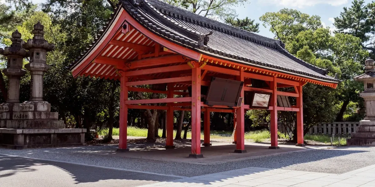 Sumiyoshi Taisha shrine's gracefully arched Sorihashi bridge and ancient torii gate in Osaka