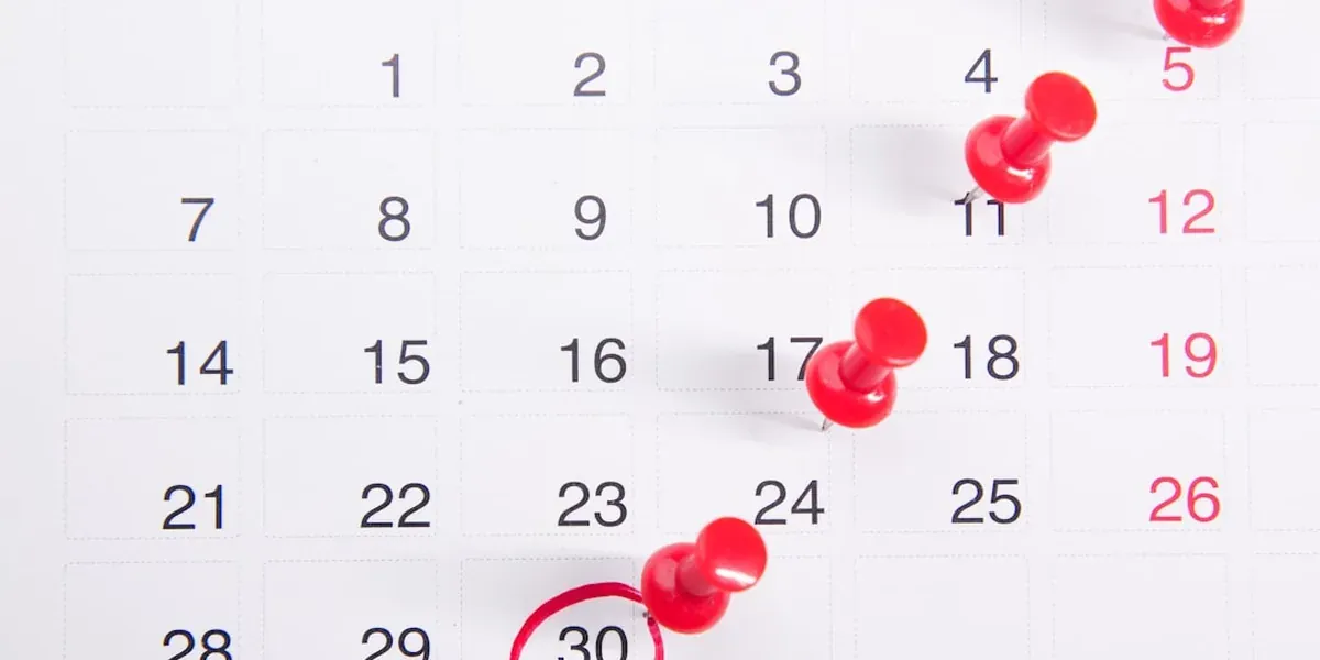 A calendar open with planning notes, illustrating trip date planning