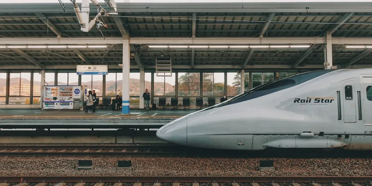 Hikari Shinkansen bullet train stopped at a Japan Rail platform with passengers boarding