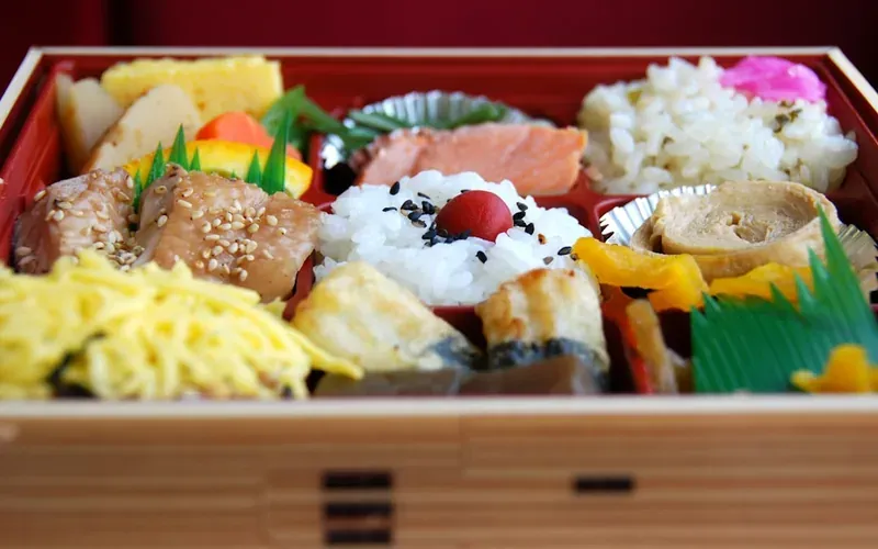 Japanese convenience store bento box and onigiri for a budget meal under ¥600