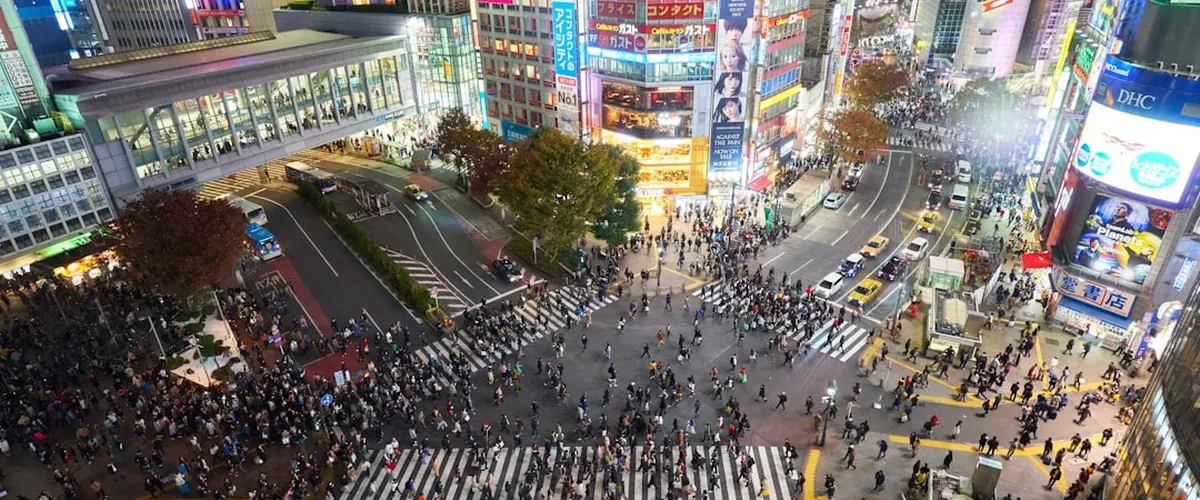 Shibuya scramble crossing in Tokyo with hundreds of pedestrians crossing simultaneously