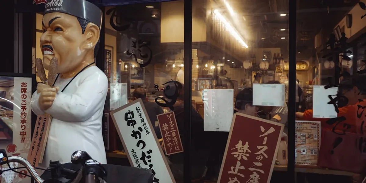 Crispy kushikatsu skewers served on a wooden board at a Japanese street food stall in Shinsekai