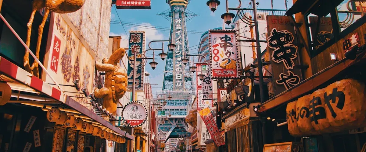 Shinsekai Osaka retro entertainment district at night with Tsutenkaku tower illuminated