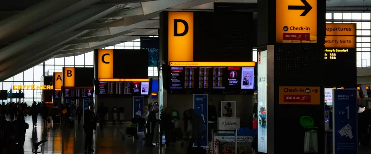 Airport currency exchange booth showing currency rates at an international terminal