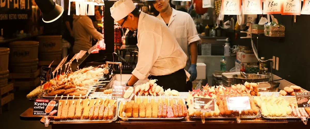 Nishiki Market in Kyoto with covered stalls displaying fresh local food, pickles, and street food samples