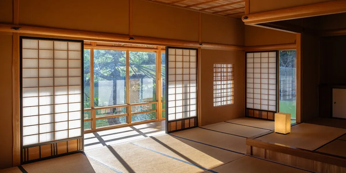 A traditional Japanese ryokan family room with tatami mats and futon bedding