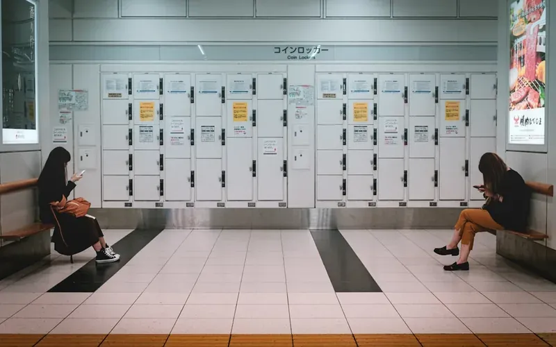 Rows of different sized coin lockers at a Japanese train station platform