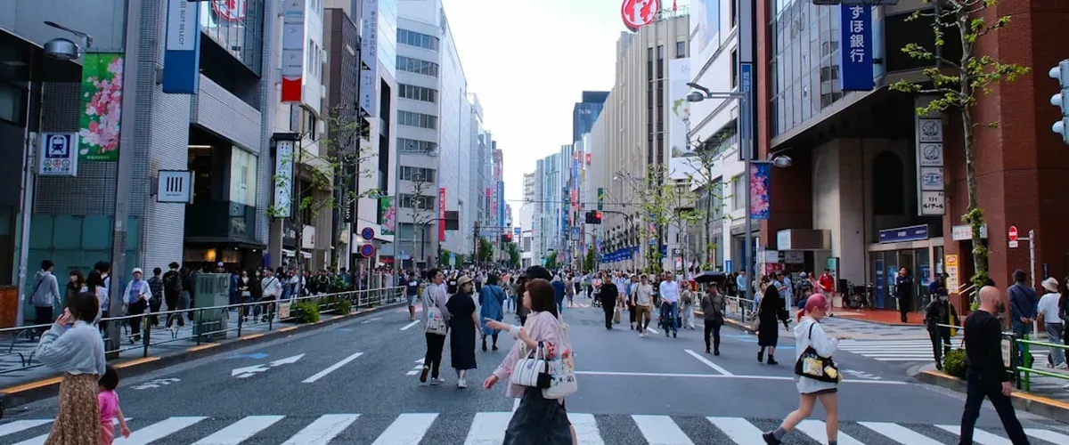 Busy Tenjin shopping street in Fukuoka Japan with shops and pedestrians
