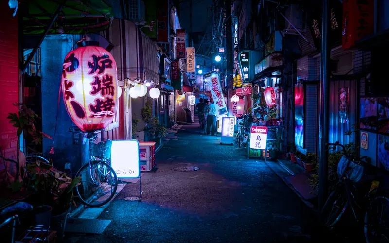 Japanese convenience store glowing brightly on a quiet Fukuoka street at night
