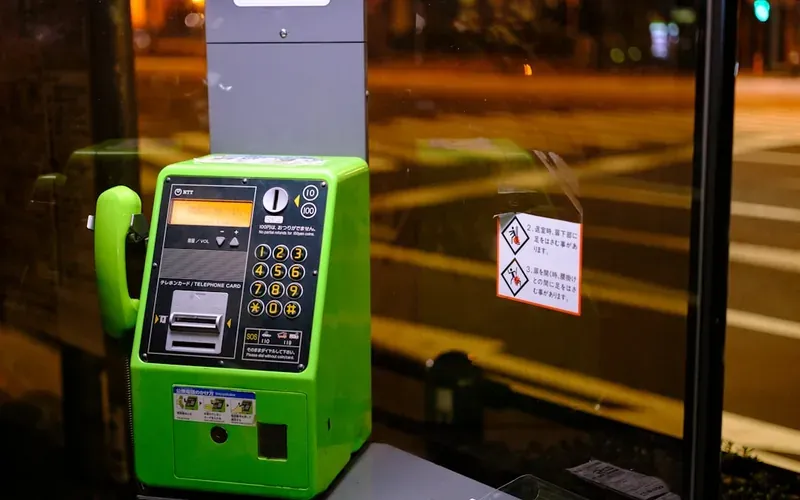 Smartphone being tapped for cashless payment at a Japanese convenience store register