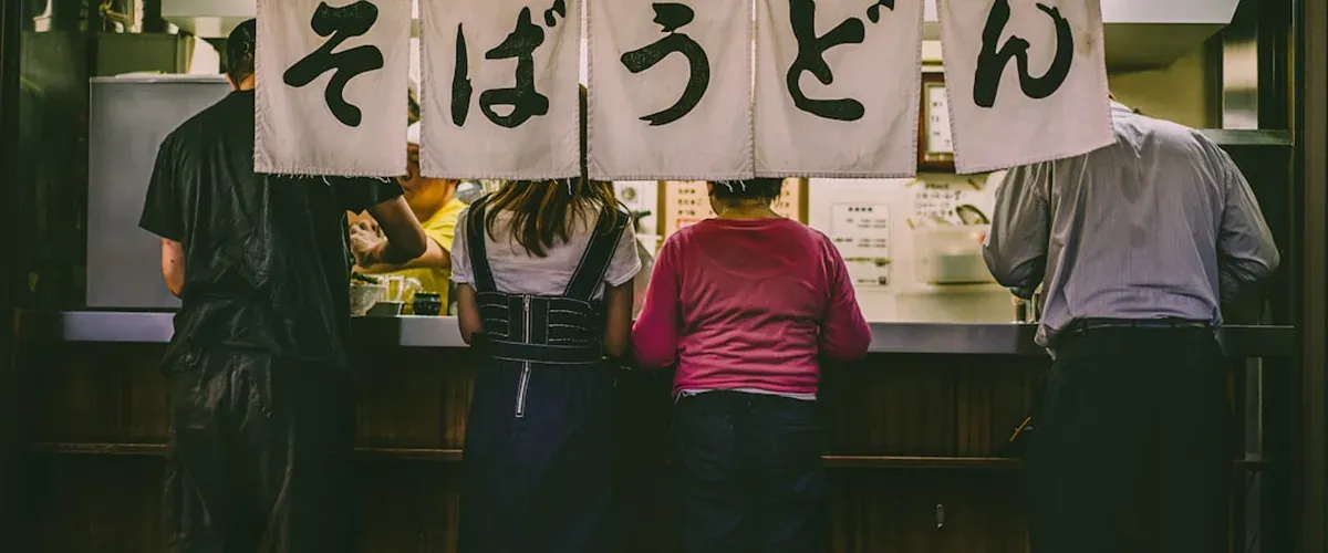 Japanese street food stall displaying skewers and local snacks at a Japanese tourist town