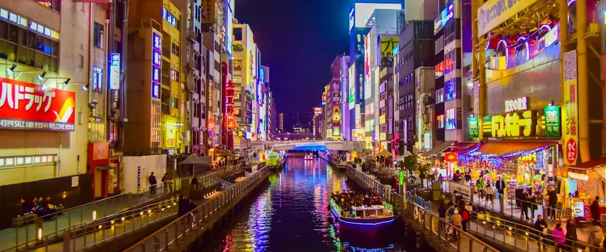 Osaka river canal at evening with city lights and reflections in the calm water