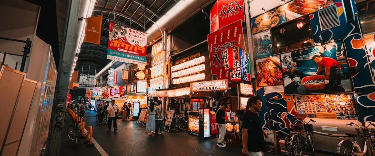 A quiet local shopping arcade in Osaka with small storefronts typical of residential neighborhoods like Nakatsu