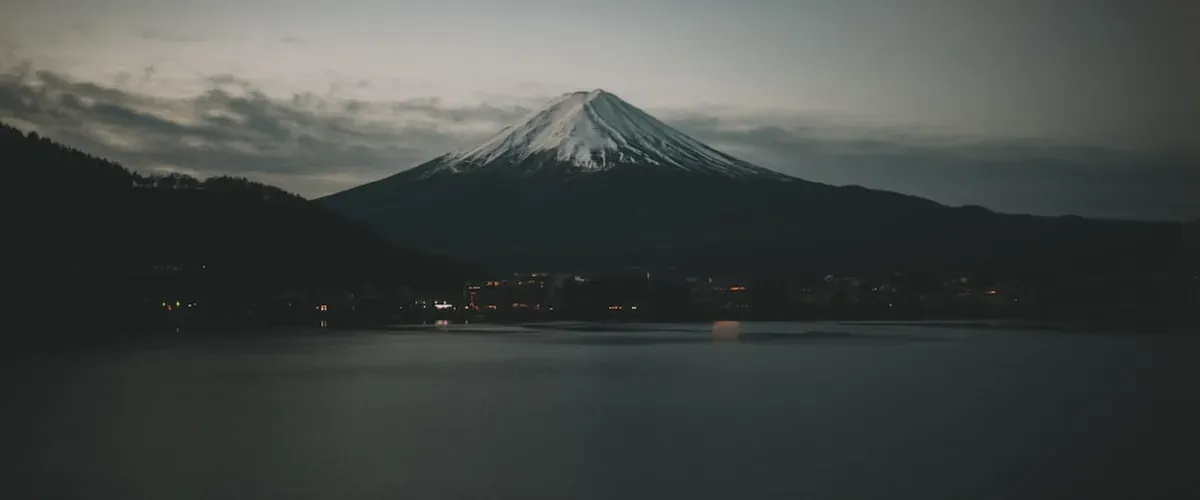 Shinkansen bullet train passing through the Japanese countryside with Mount Fuji visible in the distance