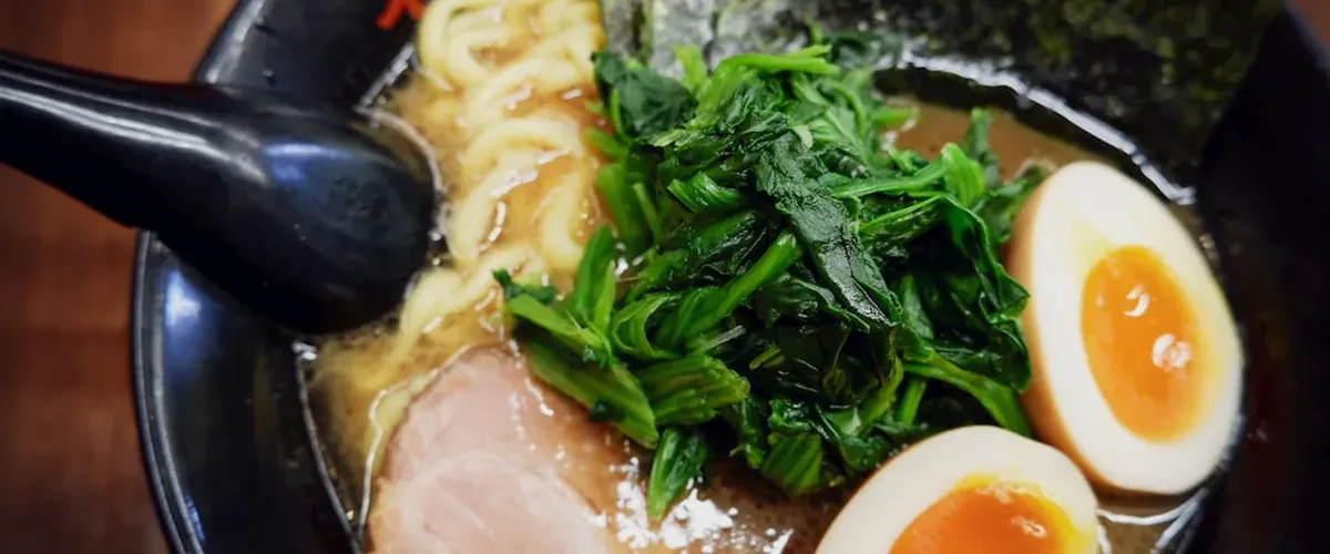 Bowl of rich Japanese ramen at a Tokyo standing ramen counter